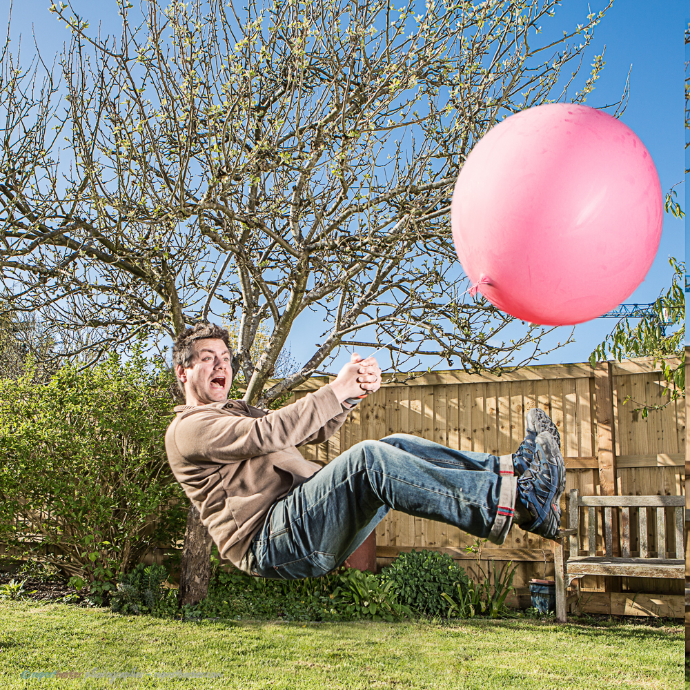 Flying balloon man pink levitation