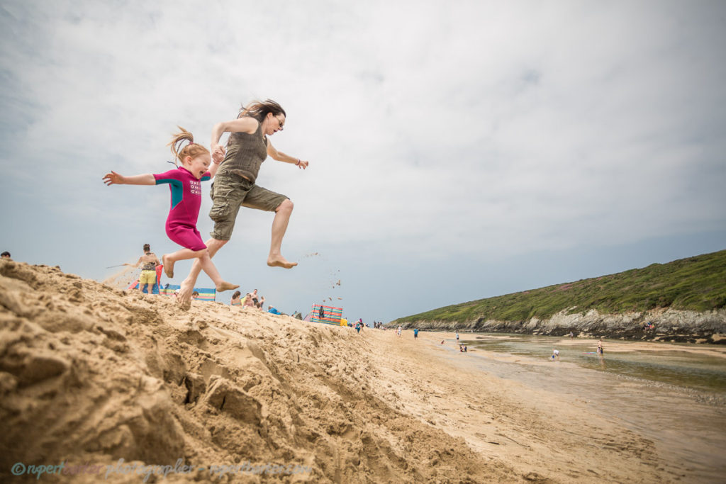 Crantock Beach sand jumping girl daughter